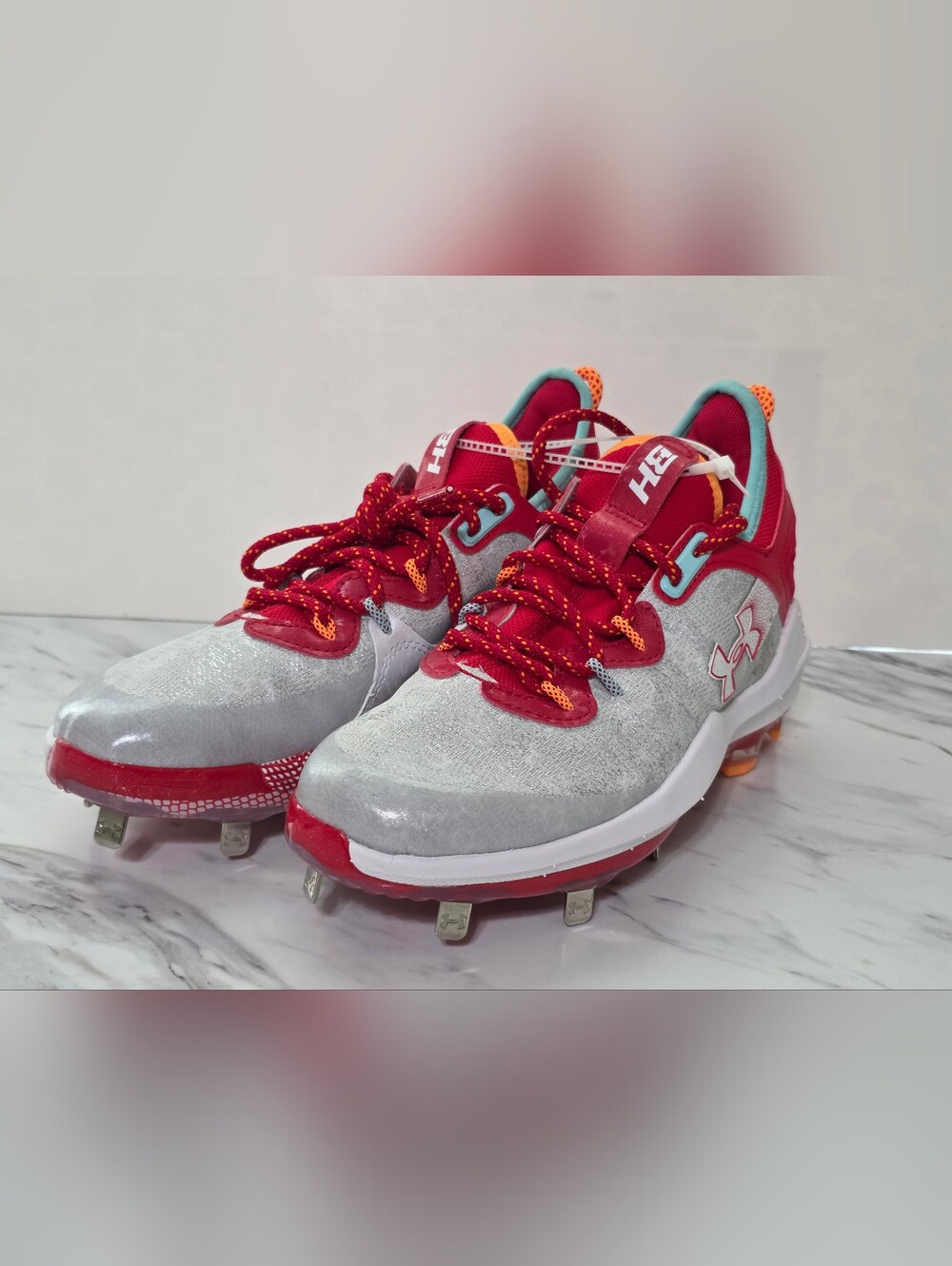 Under Armour Kids' Silver and Red Baseball Cleats with Orange Accents